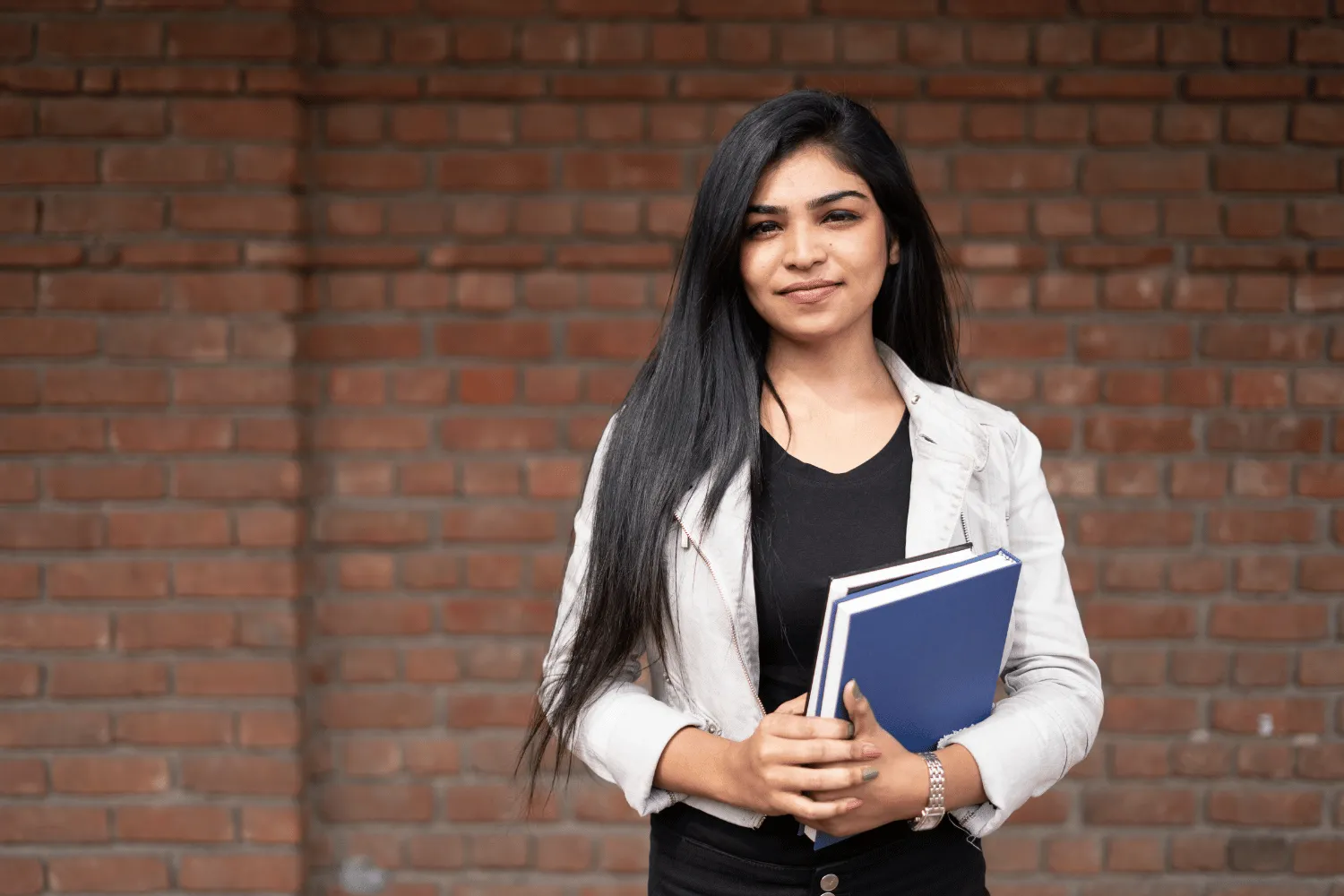 A confident graduate-admissions student with study materials