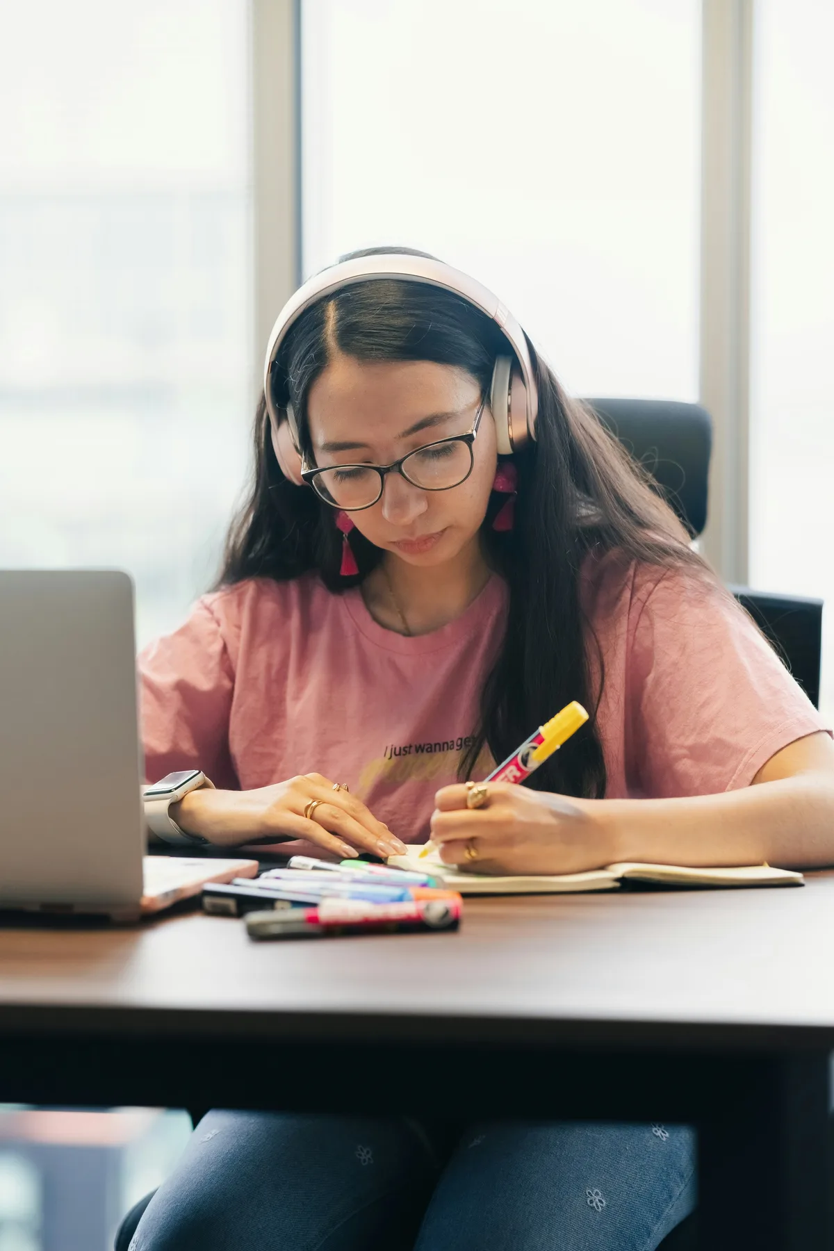 A student studying with a laptop and notes